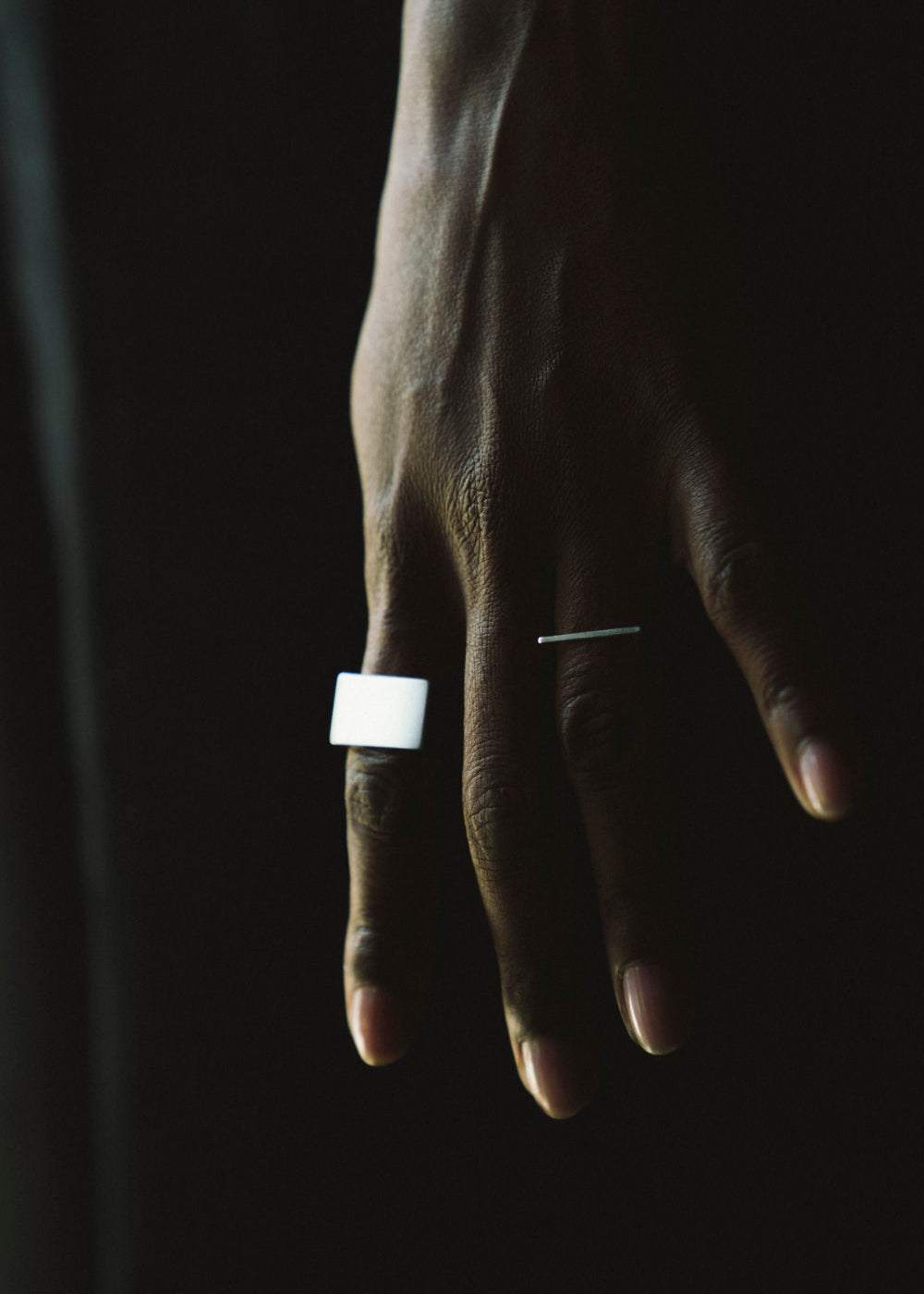 Hand with two silver rings
