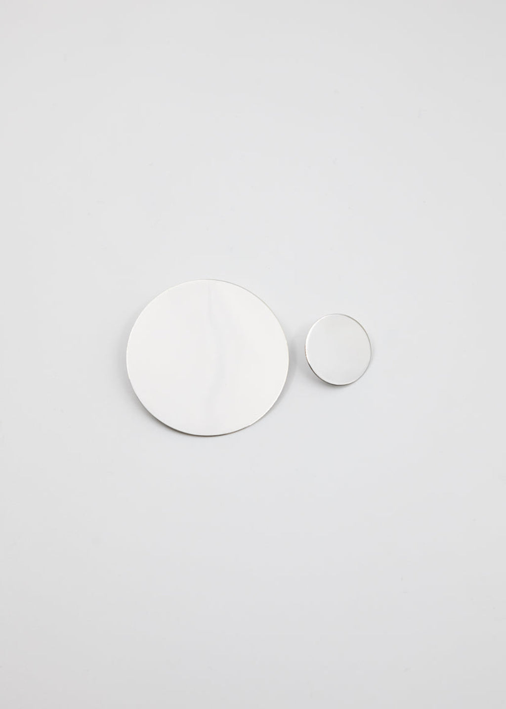 Two white circles on a light gray background