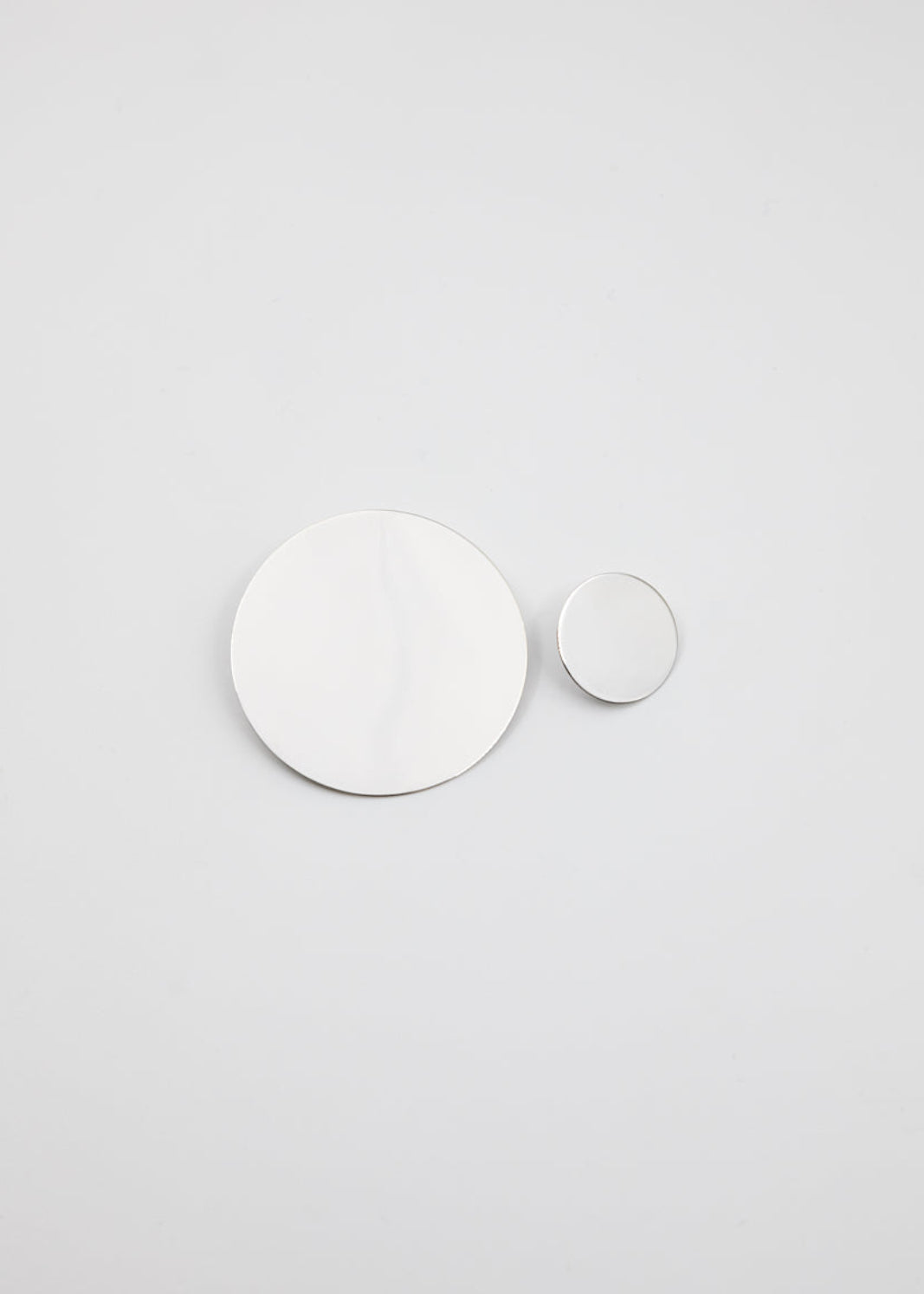 Two white circles on a light gray background
