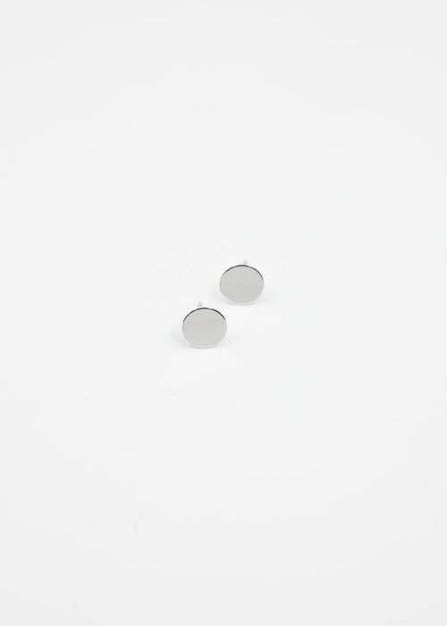 Pair of silver stud earrings on a light gray background
