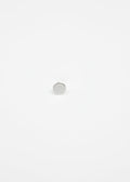 Small round silver ear stud on a white background
