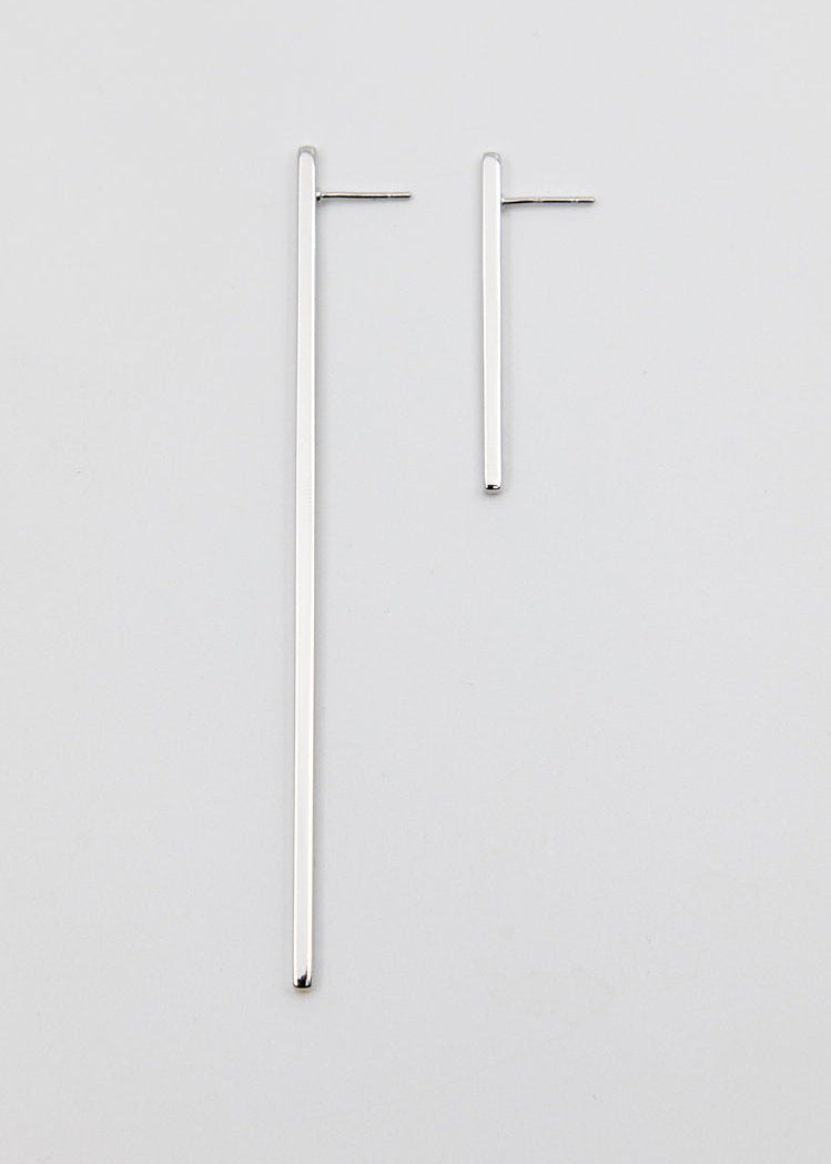 Pair of silver hoop earrings on a light gray background
