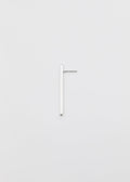 linear silver earring on a grey surface