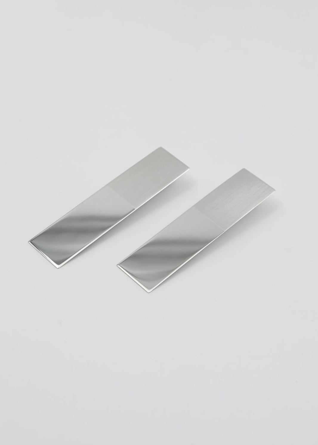 Two large mirror-polished silver earrings 