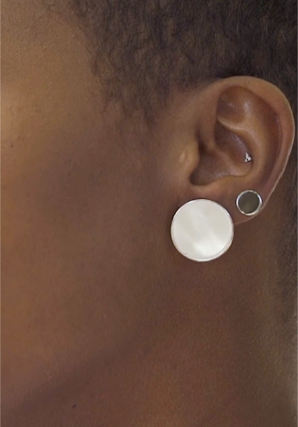 mirror-reflective rhodium plated silver earrings on ear