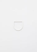 Thin linear silver ring on a light gray background